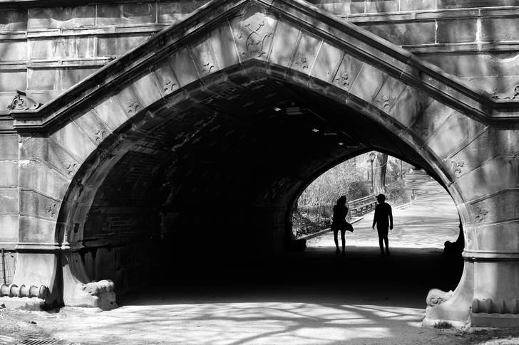 A photo of two people walking through Central Park